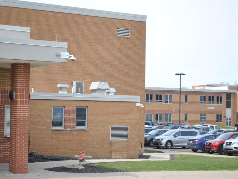 View of camera on exterior corner of building showing parking lot